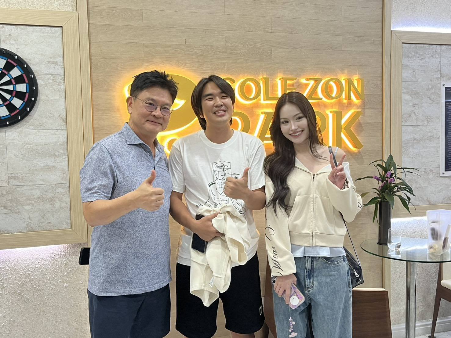 Guests with the owner at the Golfzon Park sign
